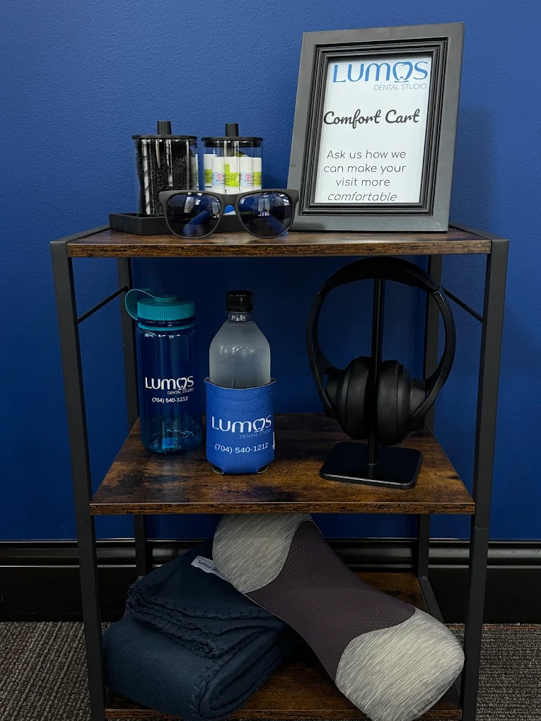 Lumos Dental Studio comfort cart with headphones, sunglasses, water, and blankets